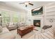 Comfortable living room with fireplace, built-in shelving, two club chairs, and a wood coffee table at 163 Neese Farm Dr, Woodstock, GA 30188