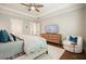 Comfortable main bedroom with tray ceiling, ceiling fan, and natural light from the large windows at 163 Neese Farm Dr, Woodstock, GA 30188