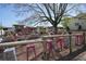 Expansive outdoor area with a mix of picnic tables and colorful stools beneath a large tree, creating a lively atmosphere at 163 Neese Farm Dr, Woodstock, GA 30188