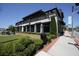 Exterior shot of a stylish restaurant featuring outdoor seating, manicured landscaping, and modern architecture at 163 Neese Farm Dr, Woodstock, GA 30188