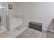 Bright bathroom boasting a large bathtub with a stylish tiled surround at 5522 Donerail St, Lithonia, GA 30058
