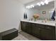 Bathroom features a dual sink vanity, modern lighting, and decorative accents at 5522 Donerail St, Lithonia, GA 30058