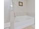 Well-lit bathroom featuring a tiled shower and separate soaking tub at 5522 Donerail St, Lithonia, GA 30058