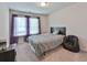 Bright bedroom features a comfortable bed, plush carpeting, and natural light at 5522 Donerail St, Lithonia, GA 30058