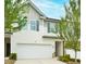 Charming townhome with a two-car garage and beautifully landscaped front yard for added curb appeal at 5522 Donerail St, Lithonia, GA 30058