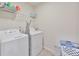 Practical laundry room with a washer, dryer, and shelving at 5522 Donerail St, Lithonia, GA 30058