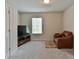 Relaxing living room with comfortable seating, a large window, and carpeting at 5522 Donerail St, Lithonia, GA 30058
