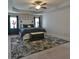 Spacious main bedroom features a tray ceiling, carpet flooring, and stylish decor at 5522 Donerail St, Lithonia, GA 30058