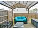 Cozy covered patio featuring comfortable seating, perfect for outdoor relaxation and entertaining in a fenced backyard at 5522 Donerail St, Lithonia, GA 30058