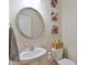The powder room boasts a pedestal sink and decorative mirror and wall art at 5522 Donerail St, Lithonia, GA 30058