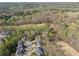 Aerial shot of a residential area with trees and a golf course in the distance at 6840 N Creekside Pt, Cumming, GA 30041