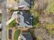 An aerial view shows the roof, landscaping, and driveway of this home on a well manicured lot at 6840 N Creekside Pt, Cumming, GA 30041