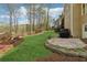 Backyard features professionally landscaped yard, stone patio, and mature trees at 6840 N Creekside Pt, Cumming, GA 30041