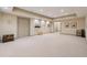 Spacious finished basement with neutral walls and carpet flooring at 6840 N Creekside Pt, Cumming, GA 30041