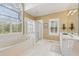 Luxury bathroom featuring jacuzzi tub, glass shower, and custom windows at 6840 N Creekside Pt, Cumming, GA 30041