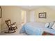 Relaxing bedroom with rocking chair, soft carpet and natural light at 6840 N Creekside Pt, Cumming, GA 30041