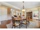 Dining room with hardwood floors offering views to the formal living room and other living spaces throughout this charming home at 6840 N Creekside Pt, Cumming, GA 30041