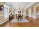 Formal dining room with hardwood floors, elegant chandelier, and classic decor, perfect for entertaining guests at 6840 N Creekside Pt, Cumming, GA 30041