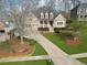 Beautiful brick home with a well-maintained lawn, front porch, and spacious driveway leading to a two-car garage at 6840 N Creekside Pt, Cumming, GA 30041