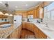 Bright kitchen features wood cabinets, white countertops, and modern appliances at 6840 N Creekside Pt, Cumming, GA 30041