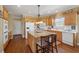 Bright kitchen features wood cabinets, granite island, and stainless-steel appliances at 6840 N Creekside Pt, Cumming, GA 30041