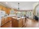 Well-lit kitchen with an island, stainless-steel appliances, and a dining area at 6840 N Creekside Pt, Cumming, GA 30041