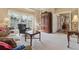Bright living room with large armoire, comfortable furniture and plantation shutters at 6840 N Creekside Pt, Cumming, GA 30041