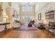 Inviting living room with hardwood floors, fireplace, and French doors, creating a cozy and stylish gathering space at 6840 N Creekside Pt, Cumming, GA 30041
