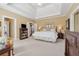 Spacious main bedroom with trey ceiling, sitting area, and adjoining bathroom at 6840 N Creekside Pt, Cumming, GA 30041