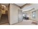 Carpeted home office with custom built-in desk and neutral color palette; stairs nearby at 6840 N Creekside Pt, Cumming, GA 30041