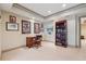 Cozy carpeted home office with custom built-in bookcase, desk, and neutral color palette at 6840 N Creekside Pt, Cumming, GA 30041
