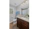 Well-lit bathroom featuring a granite-topped vanity and a toilet, enhanced by natural light and neutral tones at 1811 Tilliewood Ne Trl, Marietta, GA 30066