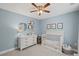 Charming Bedroom with light blue walls, a white crib, dresser, and soft accents that create a peaceful space at 1811 Tilliewood Ne Trl, Marietta, GA 30066