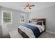 Serene bedroom featuring a dark wood bed with blue accents and abundant natural light from two windows at 1811 Tilliewood Ne Trl, Marietta, GA 30066