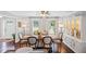 Bright dining room featuring hardwood floors, a large table, and a stylish china cabinet at 1811 Tilliewood Ne Trl, Marietta, GA 30066
