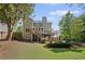 Exterior view of a well-maintained home with a spacious backyard and a deck at 1811 Tilliewood Ne Trl, Marietta, GA 30066