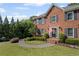 Close up of a charming two-story brick home with a well-manicured lawn and walkway at 1811 Tilliewood Ne Trl, Marietta, GA 30066