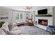 Cozy living room featuring a fireplace, hardwood floors and large windows at 1811 Tilliewood Ne Trl, Marietta, GA 30066