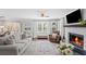 Comfortable living room features a painted brick fireplace, hardwood floors, and lots of natural light at 1811 Tilliewood Ne Trl, Marietta, GA 30066