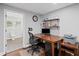 Home office featuring a dark wood desk and shelving with an adjacent bathroom, enhancing productivity and convenience at 1811 Tilliewood Ne Trl, Marietta, GA 30066