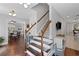Staircase with hardwood steps, white risers, and neutral paint at 1811 Tilliewood Ne Trl, Marietta, GA 30066
