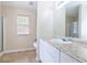 Bright bathroom with a large mirror, vanity with granite countertop, and walk-in shower at 5780 Village Loop, Fairburn, GA 30213