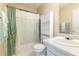 Bathroom with a vanity, toilet, and a shower-tub combo with green curtain at 5780 Village Loop, Fairburn, GA 30213