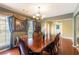Well-lit formal dining area offering an exquisite chandelier and tasteful design at 5780 Village Loop, Fairburn, GA 30213
