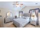 Serene main bedroom with a ceiling fan, large windows, and neutral tones at 5780 Village Loop, Fairburn, GA 30213