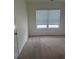 This simple bedroom features neutral carpet, one window with blinds, and is freshly painted at 184 Grafton St, Hampton, GA 30228