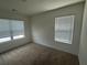 Neutral bedroom with two windows offering ample natural light, neutral carpet, and fresh paint ready for personalization at 184 Grafton St, Hampton, GA 30228