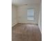 This bedroom has neutral carpet and a window bringing in natural light at 184 Grafton St, Hampton, GA 30228