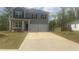 Charming two-story home featuring gray siding, dark shutters, a well-manicured lawn, and a spacious two-car garage at 184 Grafton St, Hampton, GA 30228