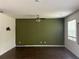 Spacious living room with wood flooring, a ceiling fan, and natural light from a large window at 184 Grafton St, Hampton, GA 30228